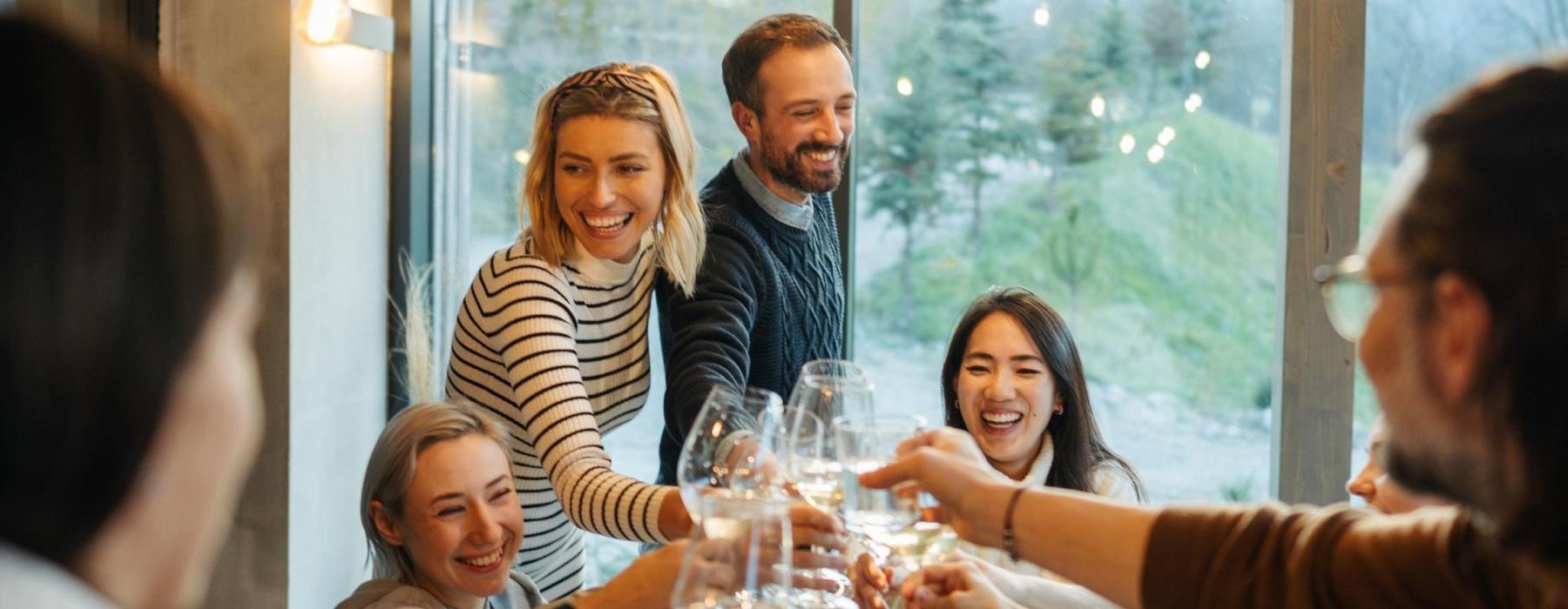 a group of people sitting around a table with food