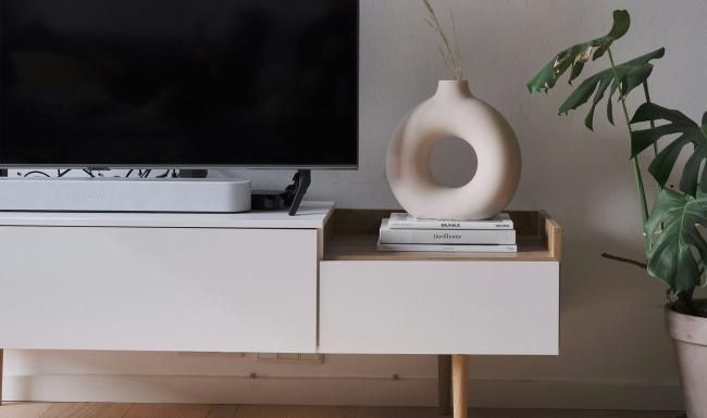 a tv on a stand with decor