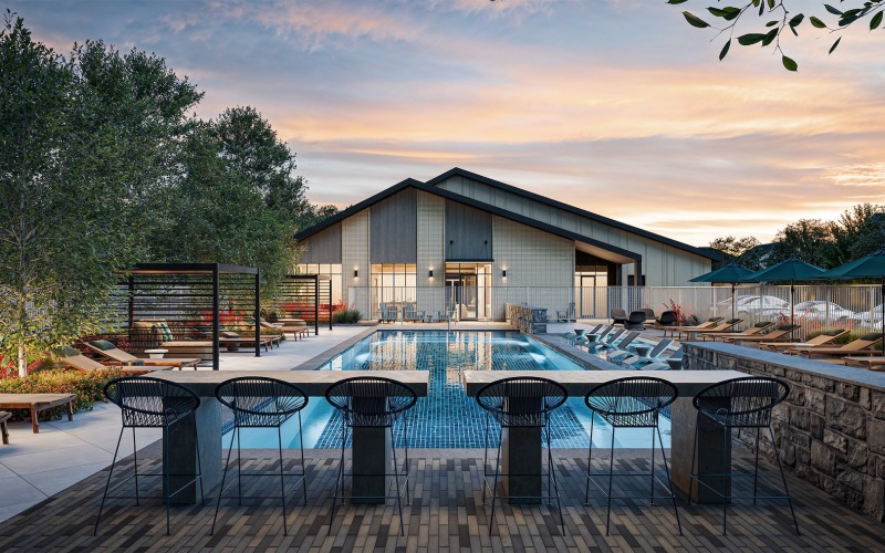 a courtyard with a pool and chairs