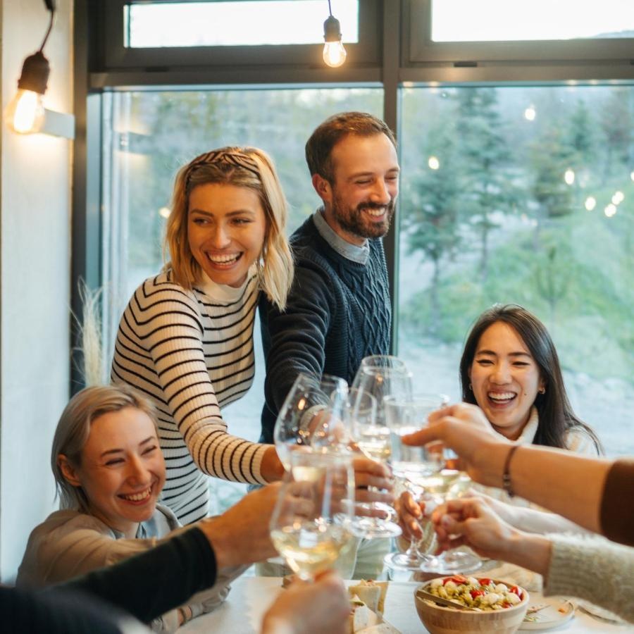 a group of people sitting around a table with food